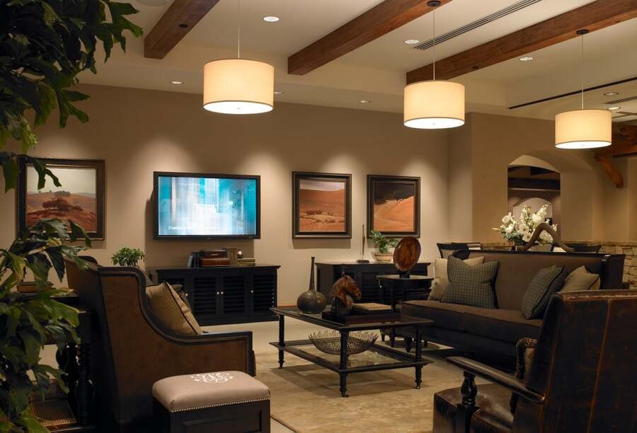 A living room is illuminated by different lighting fixtures.