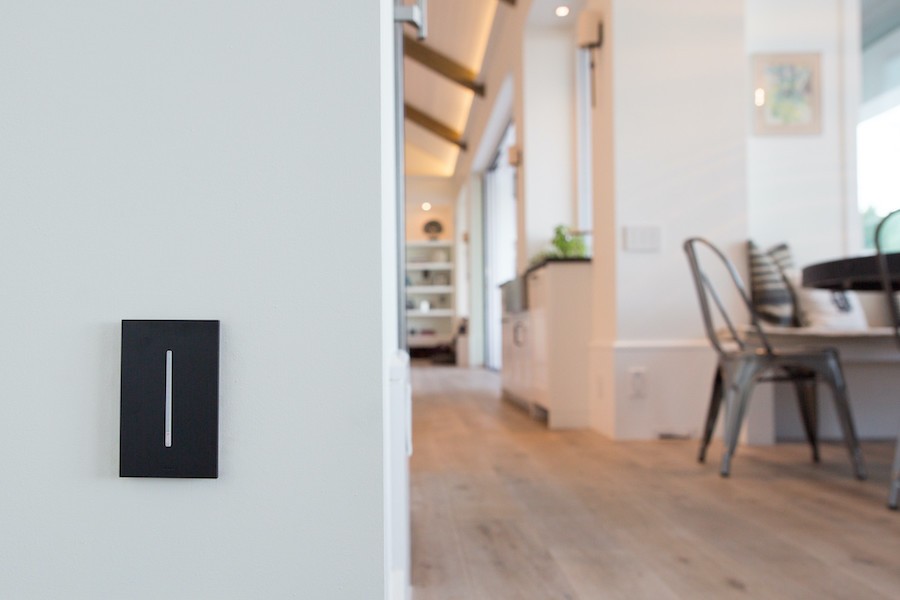  A Lutron Grafik T dimmer switch is positioned on a wall leading to a dining area.