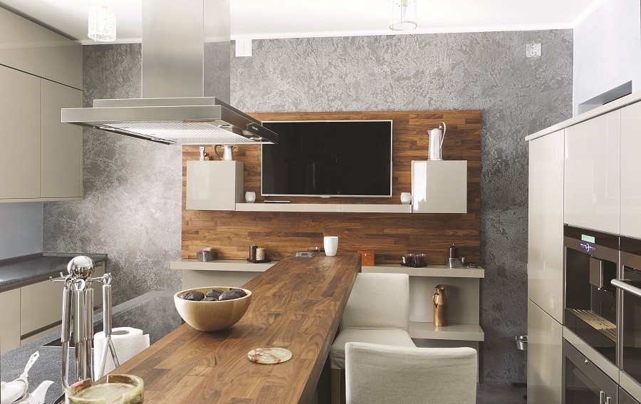 A kitchen with smart home automation equipment, including a wall-mounted TV.
