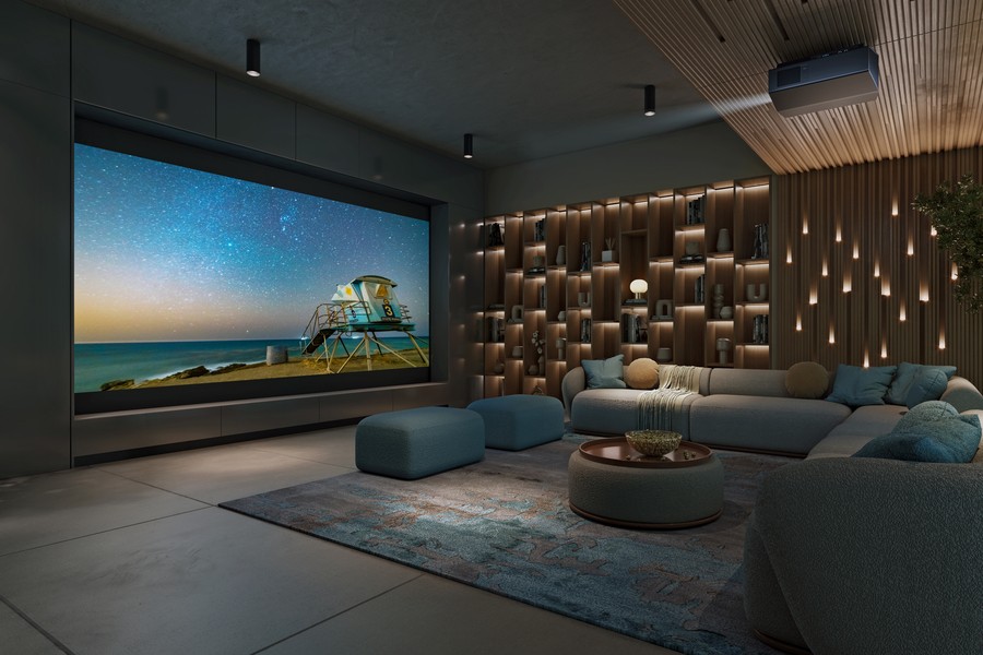 A casual home theater with a sectional, large movie screen, beautiful lighting, and a Sony projector.